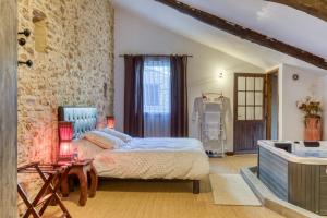 a bedroom with a large bed and a sink at Forgerole in Faugères