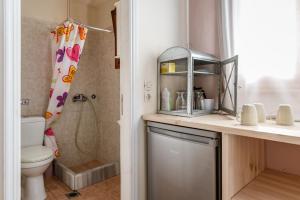 a bathroom with a toilet and a sink and a shower at En Tino 2 in Tinos +14 photos