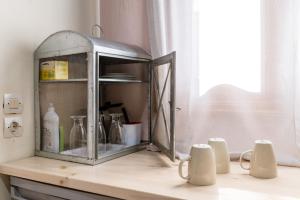 a cabinet sitting on a counter next to a window at En Tino 2 in Tinos