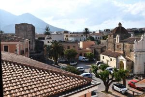 a city with cars parked in a parking lot at Hora Mare in Orosei