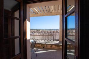 an open door with a view of a balcony at Hora Mare in Orosei +10 photos