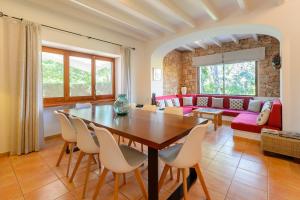 a living room with a wooden table and chairs at La Vila Ibiza in Sant Josep de sa Talaia