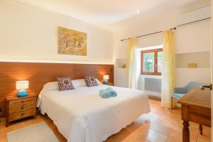 a bedroom with a large white bed and a window at La Vila Ibiza in Sant Josep de sa Talaia