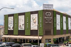 a building with advertisements on the side of it at Sojourn Spa Hotel Kuala Lumpur in Kuala Lumpur