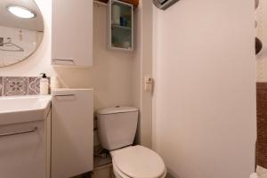 a small bathroom with a toilet and a sink at Appart Aux portes de la Camargue in Manduel +12 photos