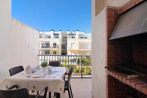 a table and chairs on a balcony with a building at Apartamento Maré Cheia Sl40 in Santa Luzia