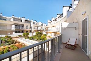 a balcony of a building with a chair at Apartamento Maré Cheia Sl40 in Santa Luzia