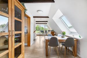 a kitchen and dining room with a table and chairs at Ferienwohnung Carolin Witt in Großsolt +15 photos