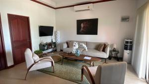 a living room with a couch and a table at Thailand Dream Village E09 in Klaeng