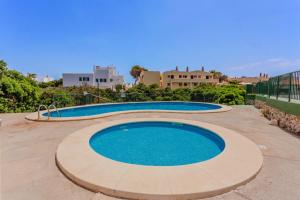 a large swimming pool in the middle of a patio at Biniforcat 21 in Cala en Forcat
