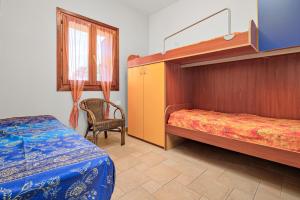 a bedroom with a bunk bed and a chair at Trilo La Rosa in Monte Petrosu +16 photos