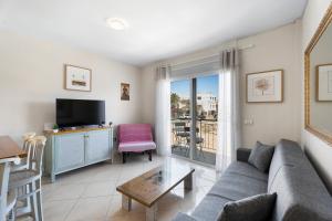 a living room with a couch and a tv at Nido Andrea in San Isidro