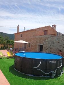 a swimming pool in front of a house at Mas de Morera in Vall dʼAlba