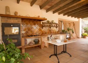 a kitchen with a table and a stove at Can Baixo in Port de Soller