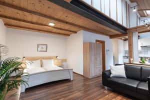 a bedroom with a bed and a couch at Schrotthof in Feldthurns