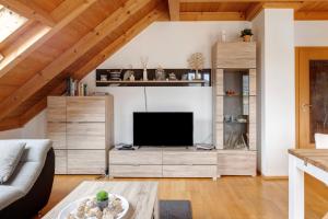 a living room with a flat screen tv at Sonnige Ferienwohnung mit Balkon in Küssaberg