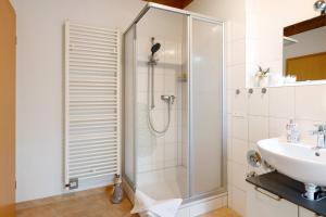 a bathroom with a shower and a sink at Sonnige Ferienwohnung mit Balkon in Küssaberg +17 photos