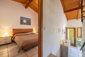 a bedroom in a house with a bed and a hallway at Villa Birgit in Monte Nai