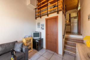 a living room with a couch and a television at Villa Birgit in Monte Nai