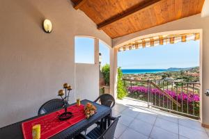a dining room with a table and a view of the ocean at Villa Birgit in Monte Nai