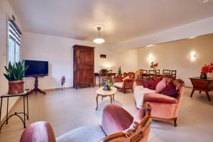 a living room with couches and a flat screen tv at Chez Emile in Brézins