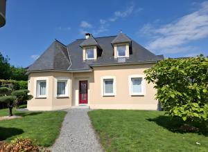a large yellow house with a red door at Chambre D'hôte - La Capucine in Bazouges