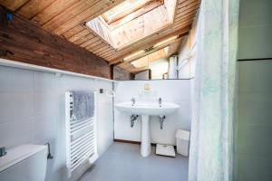 a bathroom with a sink and a skylight at Chalet Châtel - calme et spacieux in Châtel +23 photos