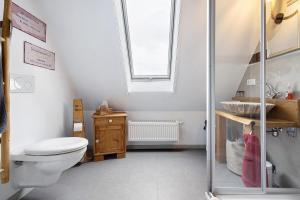a bathroom with a toilet and a sink and a window at Stub'n Ludwig in Waischenfeld +28 photos