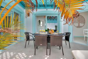 a dining room with a table and chairs at Orange Light with private pool in Corralejo