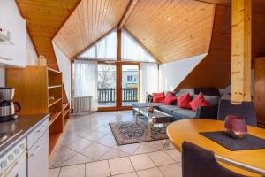a living room with a couch and a table at Gästehaus Noller in Bodman-Ludwigshafen