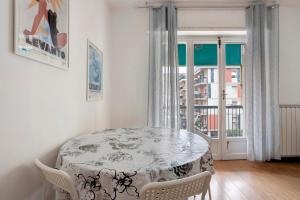 a dining room with a table and chairs and a window at Porta Delle 5 Terre in Levanto