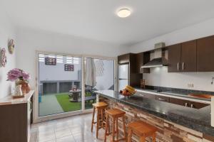 a kitchen with a counter and some chairs in it at Casa Zoiben in San Nicolás +25 photos