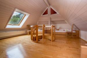 a attic room with a bed and a window at Riehle Hof in Zell am Harmersbach
