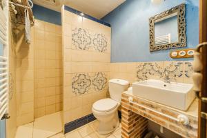 a bathroom with a toilet and a sink at El Palomar De La Cuesta in Lerma +26 photos