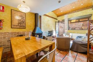 a living room with a wooden table and a fireplace at El Palomar De La Cuesta in Lerma