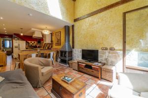 a living room with a couch and a fireplace at El Palomar De La Cuesta in Lerma