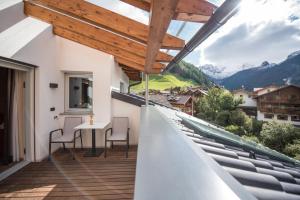 a view from the balcony of a house with a table and chairs at Alpenblick Nr 8 in Campo Tures