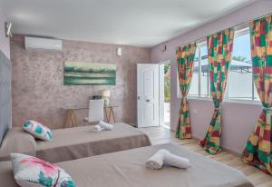 a bedroom with two beds and a window at Villa Domus Vesta in Marbella +57 photos