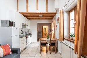 a kitchen and dining room with a table and chairs at Schrotthof in Feldthurns +42 photos
