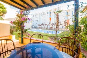 a balcony with a table and chairs and a pool at La Calma in Platja d'Aro