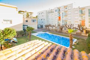 an apartment with a swimming pool and buildings at La Calma in Platja d'Aro