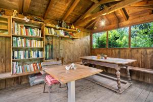 a room with a table and a book shelf with books at Apartement Annabelle in Lana