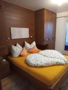 a bed with pillows on it in a room at Apartement Annabelle in Lana +6 photos