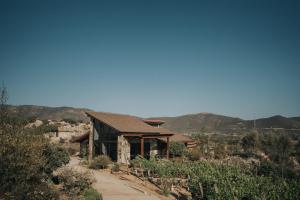 a house in the middle of a dirt road at Cabañas by 7 Valles in Valle de Guadalupe