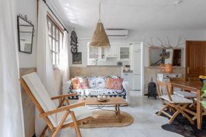 a living room with a couch and a table at Mi Casa in Caleta De Velez