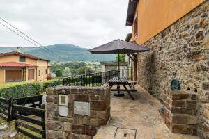 a patio with a table and an umbrella at Casa Lindelagua in Pámanes