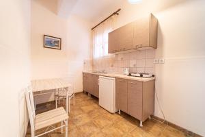 a small kitchen with a table and a counter top at Arianna Studio 15 in Paleokastritsa