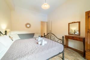 a bedroom with a bed with a mirror and a dresser at Arianna Studio 15 in Paleokastritsa
