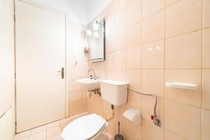 a bathroom with a toilet and a sink and a shower at Arianna Studio 15 in Paleokastritsa +16 photos