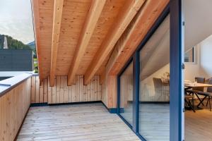 a room with a wooden ceiling and a wooden floor at Apartement Bens Auszeit Top 6 in Umhausen +14 photos